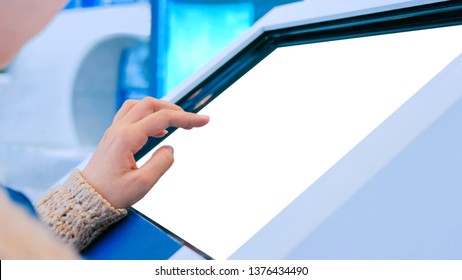 Woman using interactive digital informational kiosk with touchscreen display at urban exhibition - scrolling and touching. Education, mock-up, template and technology concept