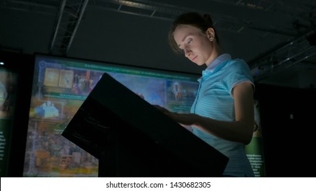 Woman Using Interactive Touchscreen Display With At Modern History Museum. Education And Modern Concept