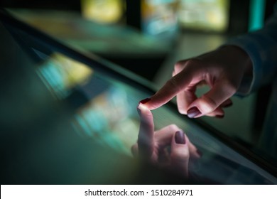Woman using interactive touchscreen display of electronic multimedia kiosk at modern museum or exhibition. Education, learning and technology concept - Shutterstock ID 1510284971