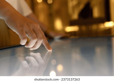 Woman using interactive touchscreen display of electronic multimedia kiosk,  Education, learning and technology concept