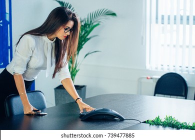woman using IP Phone for conference in office.