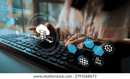 Woman Using Keyboard with Cloud Computing Graphics Displayed on Screen Featuring Technology and Data Analysis Concepts. Entropy.