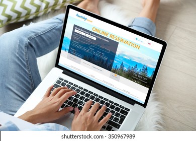 Woman using laptop to book hotel online - Powered by Shutterstock