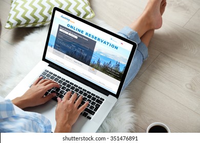 Woman using laptop to book hotel online - Powered by Shutterstock