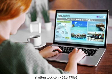 Woman Using Laptop To Book Hotel Online