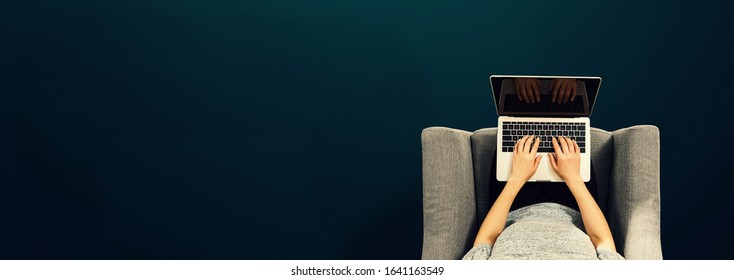 Woman using a laptop computer overhead view