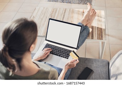 Woman using laptop computer and paying with credit card at home. Blank white empty display screen mock up template, copy space. Online shopping, home work, ecommerce, internet banking concept - Shutterstock ID 1687157443