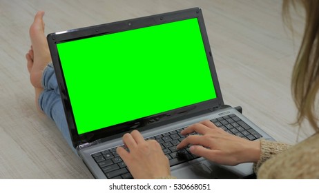 Woman Using Laptop With Green Screen. Woman's Hands Typing On A Laptop Keyboard. Business, Communication, Freelance And Internet Concept