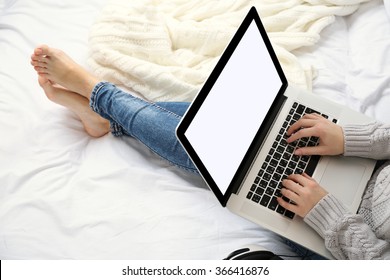 Woman Using Laptop On Her Bed