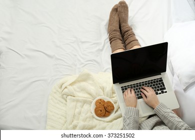 Woman Using Laptop On Her Bed