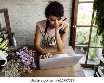 Woman Using Laptop for Online Flower Shop