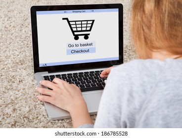 Woman Using Laptop With Online Shopping Application On A Screen