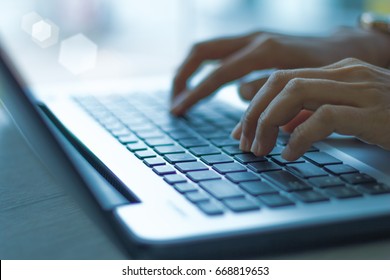 woman using laptop, searching web, browsing information, having workplace at home  / soft focus picture / blue tone