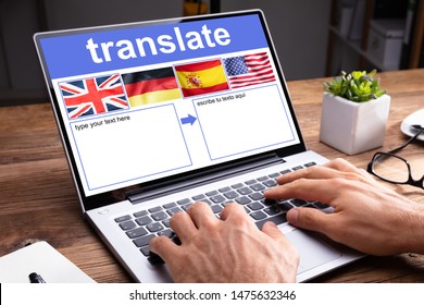 Woman Using Laptop Showing Language Translate Application With Country Flag At Home