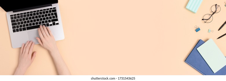 Woman Using Laptop. Student Workspace On A Beige Background. Banner With Copy Space.