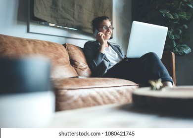 Woman Using Laptop And Talking On The Phone, Cozy Studio Apartment