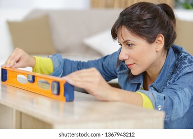 Woman Using Leveling Tool