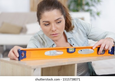 A Woman Using Leveling Tool