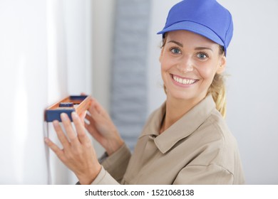 Woman Using Leveling Tool At Home