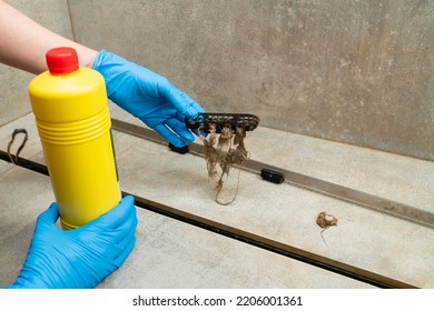 Woman Using Liquid Drain Cleaners To Clean Bathroom Sink Drain, Closeup