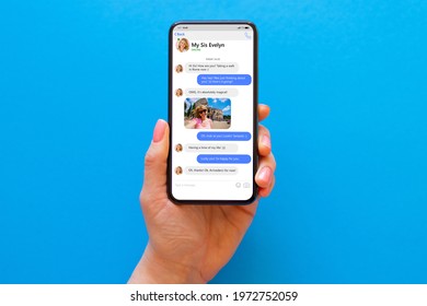 Woman using messaging app on her phone, mockup of sample chat application interface on blue background