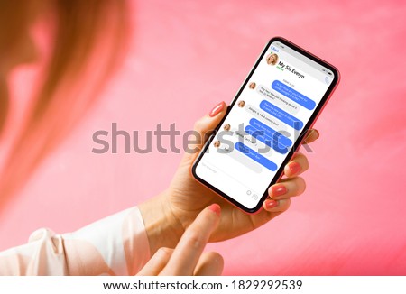 Woman using messaging app on mobile phone. Mockup of sample chat application interface.