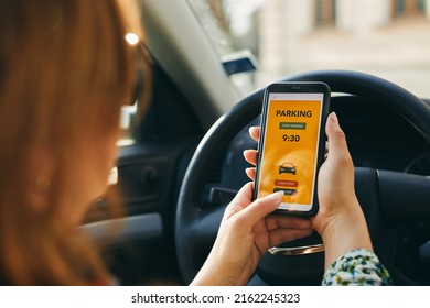 Woman Using Mobile Parking App On Smartphone. Driver Using Smartphone To Pay For Parking. Car Park Application On Mobile Phone. Convenience Paying For Parking Using Fast Payment Online. Mobile App