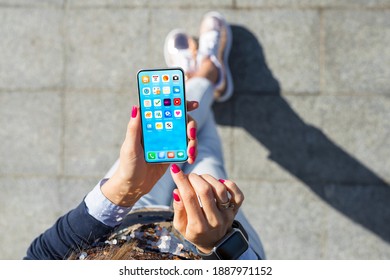 Woman using mobile phone, home screen mockup with app icons - Shutterstock ID 1887971152