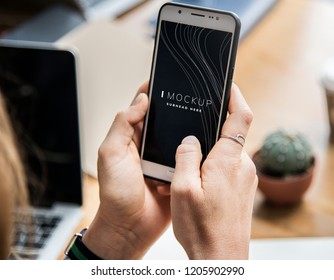 Woman using a mobile phone mockup in an office