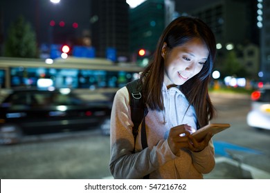 Woman Using Mobile Phone At Night