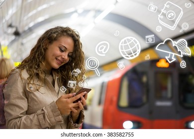 woman using a mobile phone on the tube underground station, London