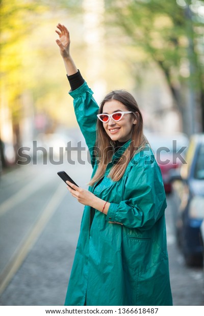 woman using a mobile\
phone to order a taxi