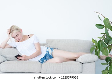 Woman Using Mobile Phone Updating Facebook Status. Leisure Habits. Communication And Social Network Addiction