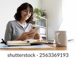 Woman using mobile phone working at home. Copy space. Working from home concept.