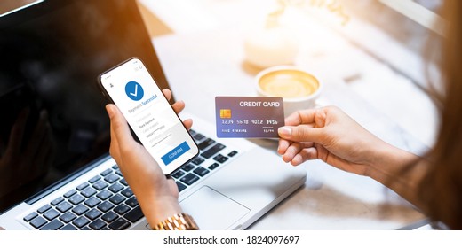 Woman using mobile smart phone online banking with Credit card money transfer successful filling in billing information in laptop purchasing products on ecommerce store payment shopping transaction
