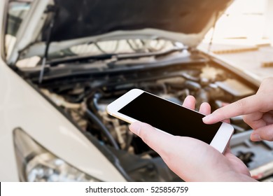 Woman Using Mobile Smart Phone With Broken Down Car Background, Emergency Service Concept