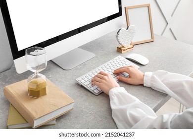 Woman using modern computer on light table
