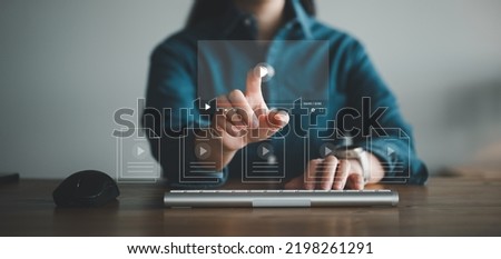 woman using mouse and keyboard for streaming online on virtual screen, watching video on internet, live concert, show or tutorial, content online.	
