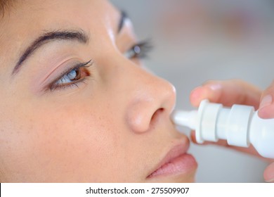 Woman Using A Nasal Spray