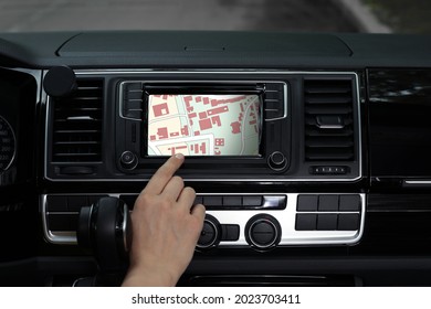 Woman using navigation system while driving car, closeup
