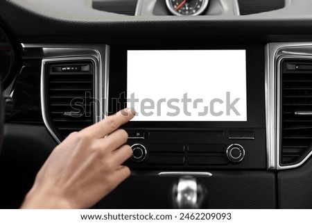 Woman using navigation system while driving her car, closeup