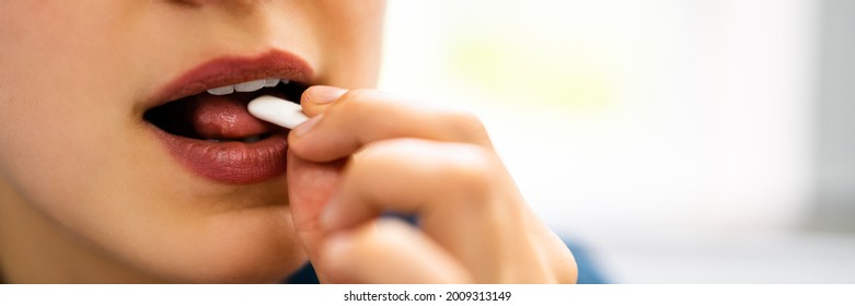 Woman Using Nicotine Gum To Quit Smoking. Nicotine Replacement Therapy