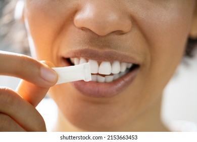 Woman Using Nicotine Gum To Quit Smoking. Nicotine Replacement Therapy