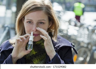 Woman Using Nose Spray