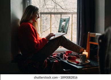 Woman Using Online Dating App On Laptop. Valentines Day During The Coronavirus Outbreak. Love At Distance, Loneliness In Self-isolation In The Time Of Coronavirus.