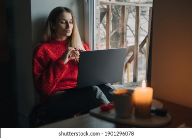 Woman Using Online Dating App On Laptop. Valentines Day During The Coronavirus Outbreak. Love At Distance, Loneliness In Self-isolation In The Time Of Coronavirus.