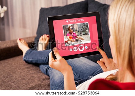 Woman using online dating app on tablet