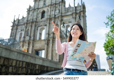 Woman using paper map in Macao city - Shutterstock ID 549905377