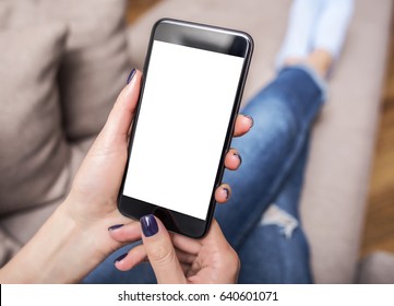 Woman Using Phone With Copy Space At Home On The Couch.