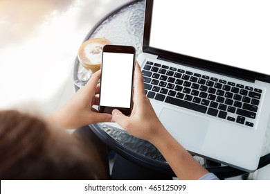 woman using phone on work table in coffee shop